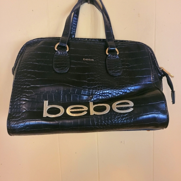 Bebe, Black Handbag. Handbag studs on bottom. Gold lettering. - Picture 1 of 4